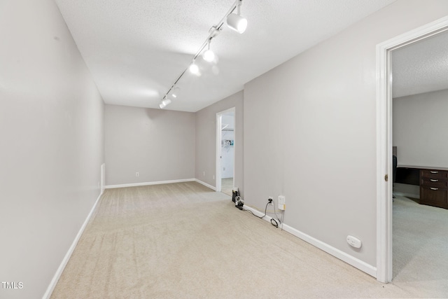 905 Balmoral Dr, Cary, NC 27511 - carpeted empty room with rail lighting, baseboards, and a textured ceiling