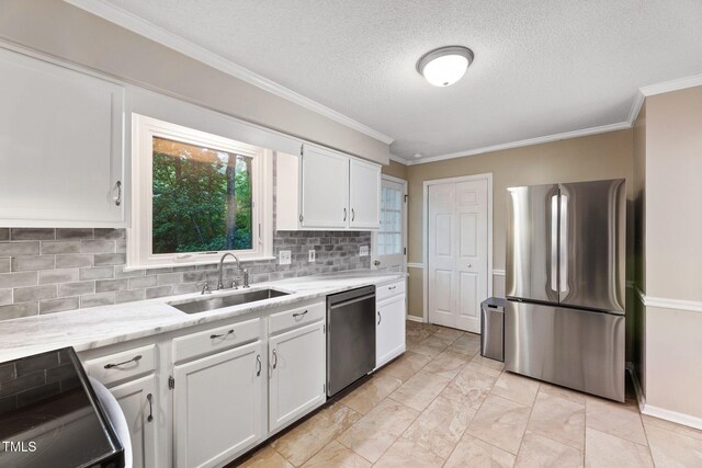 905 Balmoral Dr, Cary, NC 27511 - kitchen with appliances with stainless steel finishes, a sink, white cabinets, backsplash, and ornamental molding