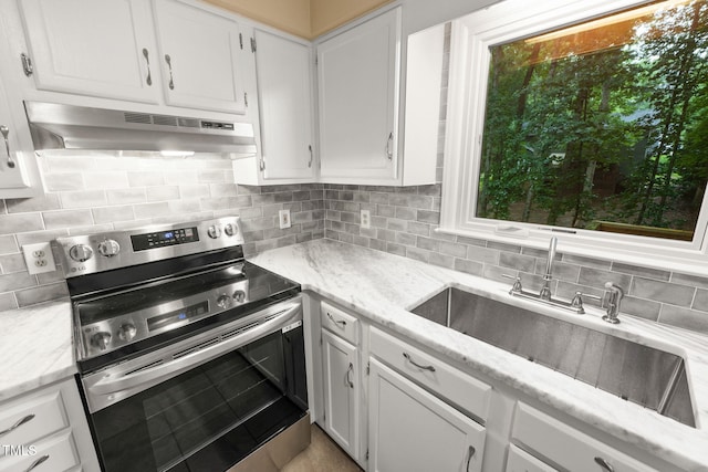 905 Balmoral Dr, Cary, NC 27511 - kitchen featuring stainless steel range with electric stovetop, under cabinet range hood, a sink, and white cabinets