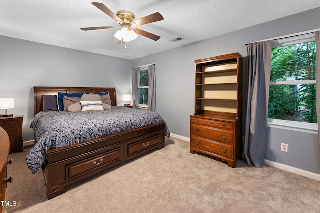 905 Balmoral Dr, Cary, NC 27511 - bedroom featuring light colored carpet, multiple windows, baseboards, and a textured ceiling