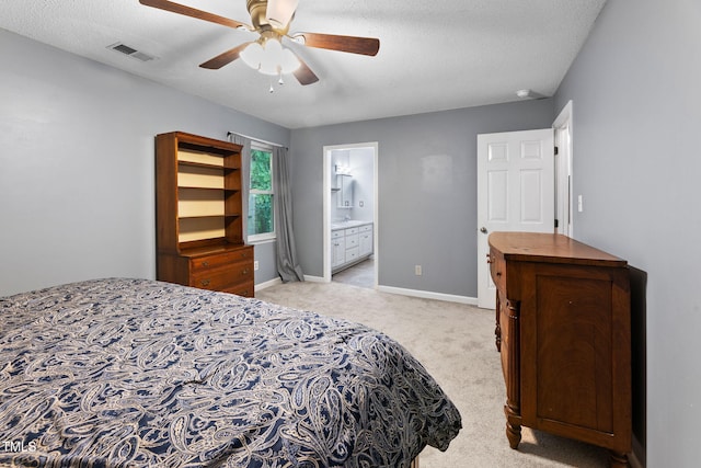 905 Balmoral Dr, Cary, NC 27511 - bedroom with light carpet, baseboards, ceiling fan, ensuite bath, and a textured ceiling