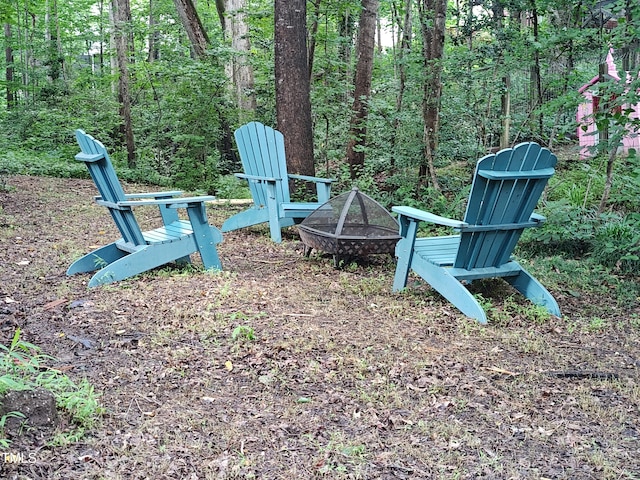 905 Balmoral Dr, Cary, NC 27511 - view of yard featuring an outdoor fire pit and a wooded view