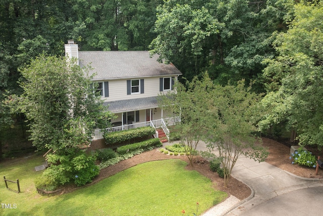 905 Balmoral Dr, Cary, NC 27511 - view of front of home with driveway, a porch, a chimney, and a front lawn