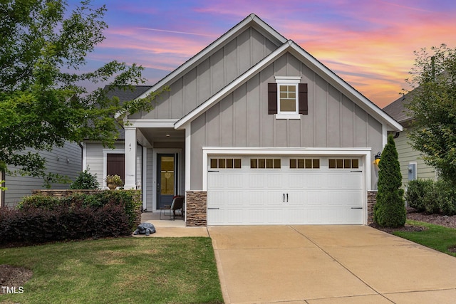 47 Coventry Ln, Chapel Hill, NC 27516 - view of front of house featuring board and batten siding, stone siding, concrete driveway, and a front lawn