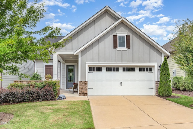 47 Coventry Ln, Chapel Hill, NC 27516 - view of front of home with board and batten siding, driveway, stone siding, and a front lawn