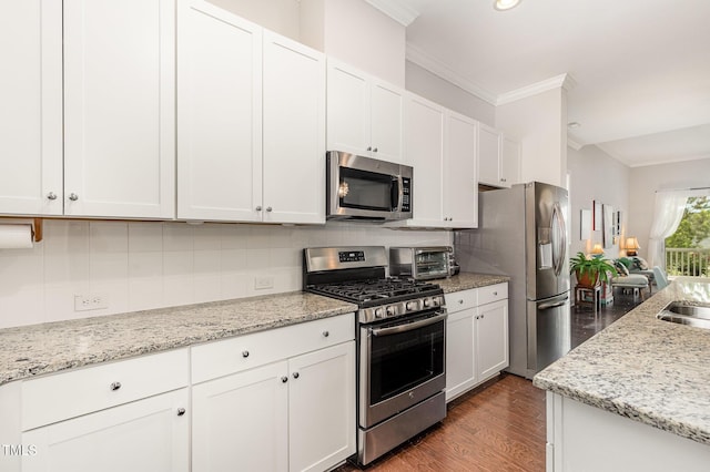 47 Coventry Ln, Chapel Hill, NC 27516 - kitchen with appliances with stainless steel finishes, crown molding, decorative backsplash, white cabinetry, and dark wood-style floors