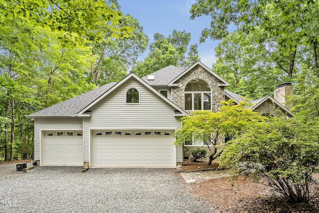 2606 Sherbrooke Dr, Durham, NC 27712 - view of front of home featuring driveway, roof with shingles, stone siding, and a chimney