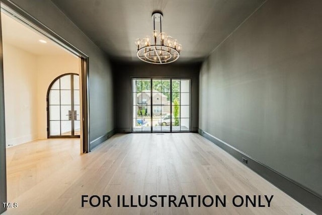 3422 Redbud Ln, Raleigh, NC 27607 - spare room featuring a chandelier, wood finished floors, and baseboards