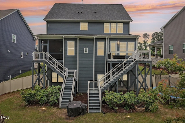 421 Gilpin Way, Cary, NC 27519 - back of house at dusk with stairway and a sunroom
