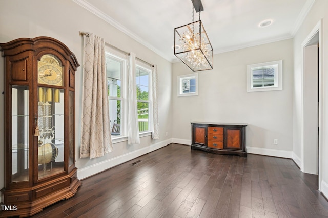 421 Gilpin Way, Cary, NC 27519 - unfurnished dining area featuring a chandelier, baseboards, crown molding, and dark wood finished floors