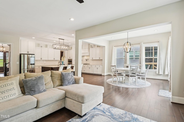 421 Gilpin Way, Cary, NC 27519 - living room featuring a chandelier, recessed lighting, baseboards, and dark wood-style floors