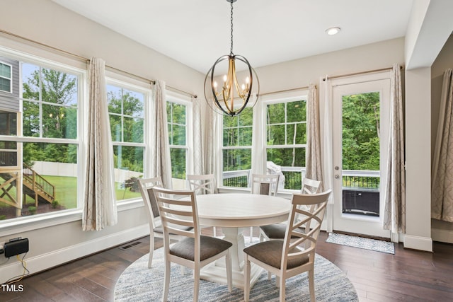 421 Gilpin Way, Cary, NC 27519 - dining area with a chandelier, dark wood finished floors, and baseboards