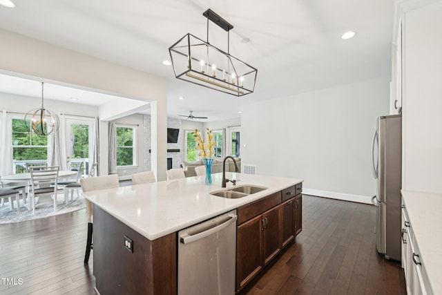 421 Gilpin Way, Cary, NC 27519 - kitchen featuring a sink, stainless steel appliances, a chandelier, dark wood-type flooring, and a kitchen island with sink