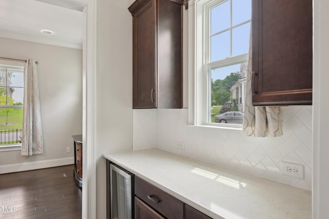 421 Gilpin Way, Cary, NC 27519 - kitchen featuring wine cooler, baseboards, dark wood-style floors, ornamental molding, and backsplash