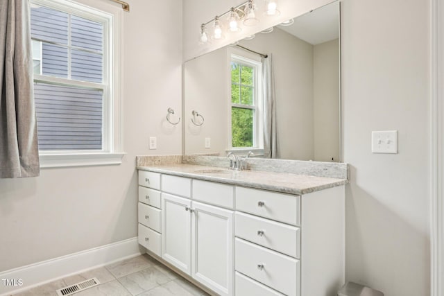 421 Gilpin Way, Cary, NC 27519 - bathroom featuring vanity, baseboards, and marble look tile flooring