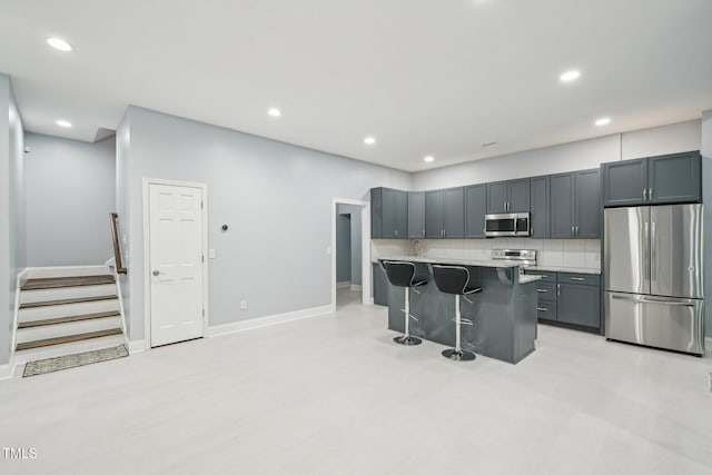 421 Gilpin Way, Cary, NC 27519 - kitchen with appliances with stainless steel finishes, a kitchen bar, recessed lighting, decorative backsplash, and baseboards