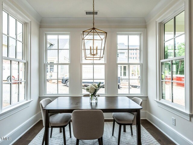 2641 Sidford Aly, Raleigh, NC 27608 - dining area with a chandelier, baseboards, ornamental molding, and dark wood-type flooring