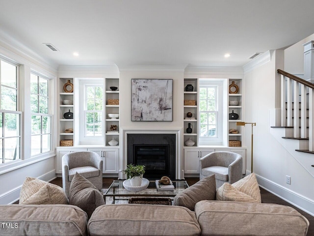 2641 Sidford Aly, Raleigh, NC 27608 - living area with stairway, baseboards, crown molding, and a fireplace with flush hearth