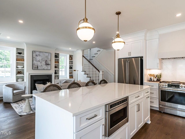 2641 Sidford Aly, Raleigh, NC 27608 - kitchen with stainless steel appliances, ornamental molding, dark wood-type flooring, a kitchen island, and open floor plan