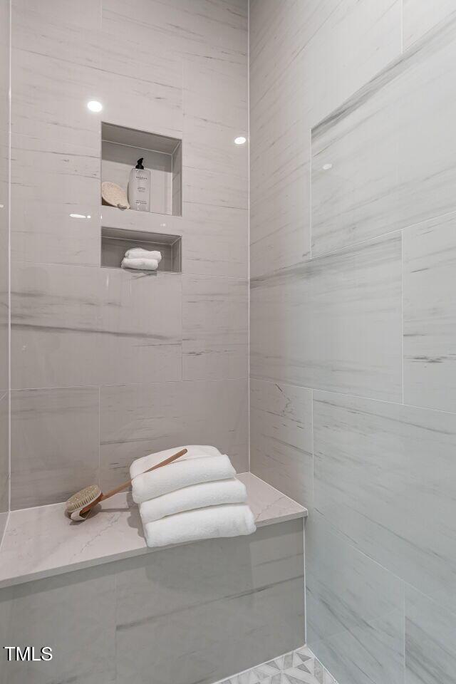 2641 Sidford Aly, Raleigh, NC 27608 - bathroom with tiled shower and tile walls