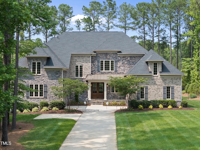 7545 Hasentree Club Dr, Wake Forest, NC 27587 - french country inspired facade featuring french doors, a front lawn, stone siding, and roof with shingles