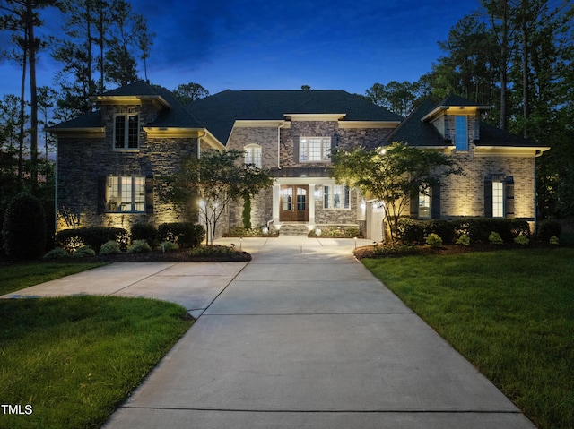 7545 Hasentree Club Dr, Wake Forest, NC 27587 - view of front of house with stone siding, a front yard, french doors, and curved driveway