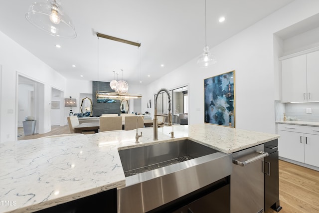 7545 Hasentree Club Dr, Wake Forest, NC 27587 - kitchen with a sink, pendant lighting, backsplash, light stone countertops, and recessed lighting
