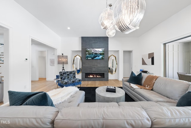 7545 Hasentree Club Dr, Wake Forest, NC 27587 - living room with light wood finished floors, a chandelier, a tiled fireplace, and recessed lighting