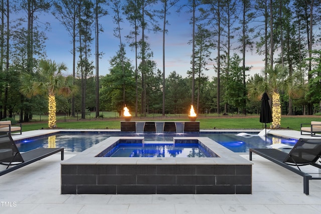7545 Hasentree Club Dr, Wake Forest, NC 27587 - pool at dusk with an in-ground hot tub, a patio area, view of wooded area, and a yard