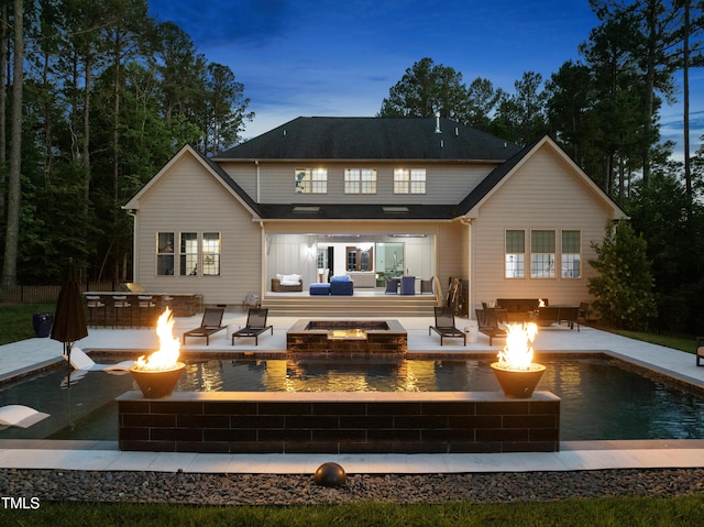 7545 Hasentree Club Dr, Wake Forest, NC 27587 - back of property featuring a patio, an outdoor living space with a fire pit, and a pool with connected hot tub