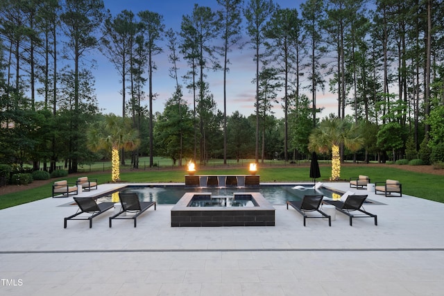 7545 Hasentree Club Dr, Wake Forest, NC 27587 - patio terrace at dusk with an in-ground hot tub, a patio area, a yard, and view of scattered trees