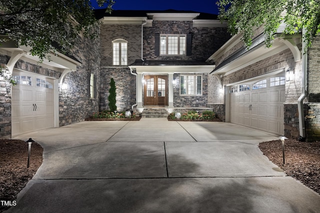 7545 Hasentree Club Dr, Wake Forest, NC 27587 - view of front facade featuring driveway, french doors, and stone siding