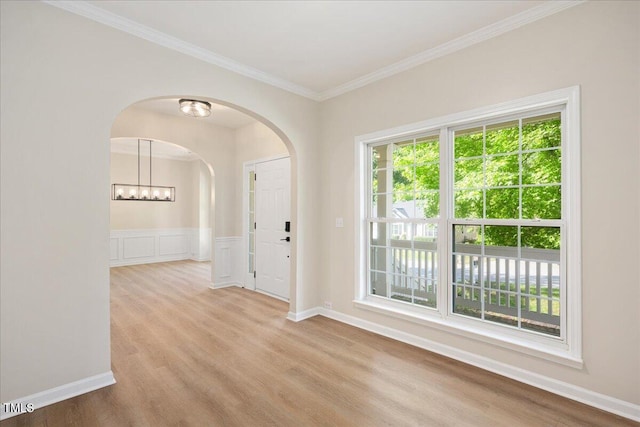 121 River Hills Dr, Clayton, NC 27527 - spare room with arched walkways, ornamental molding, healthy amount of natural light, wood finished floors, and baseboards