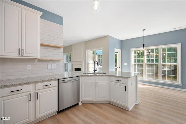 121 River Hills Dr, Clayton, NC 27527 - kitchen featuring dishwasher, a sink, open shelves, a peninsula, and light wood-style floors