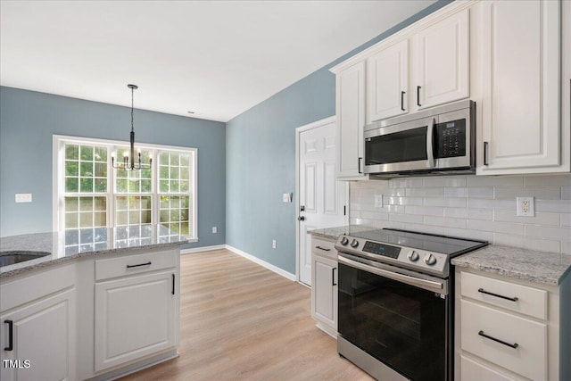 121 River Hills Dr, Clayton, NC 27527 - kitchen with stainless steel appliances, decorative backsplash, light wood-type flooring, and white cabinets
