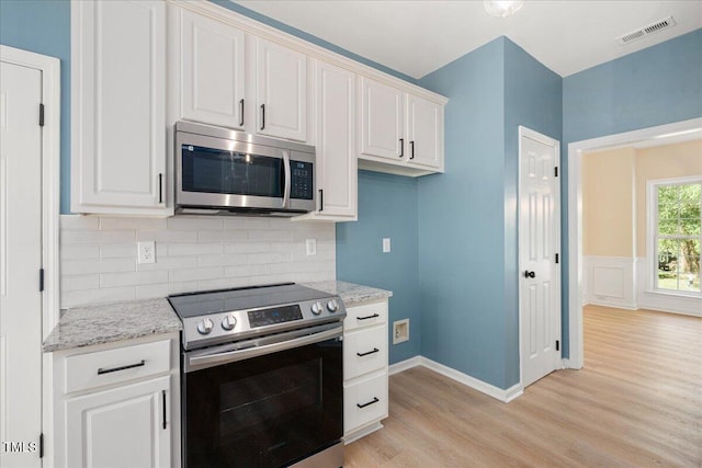 121 River Hills Dr, Clayton, NC 27527 - kitchen featuring stainless steel appliances, light wood-style flooring, white cabinets, and decorative backsplash