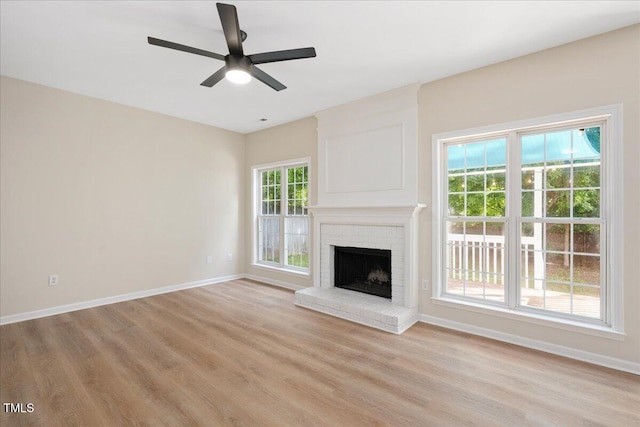 121 River Hills Dr, Clayton, NC 27527 - unfurnished living room featuring light wood-style floors, baseboards, ceiling fan, and a fireplace