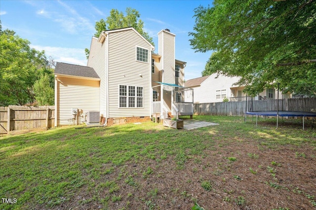 121 River Hills Dr, Clayton, NC 27527 - rear view of house with crawl space, a trampoline, a chimney, and cooling unit