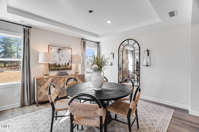 1021 Dillon Lake Dr, Knightdale, NC 27545 - dining room featuring a raised ceiling, light wood-type flooring, baseboards, and recessed lighting