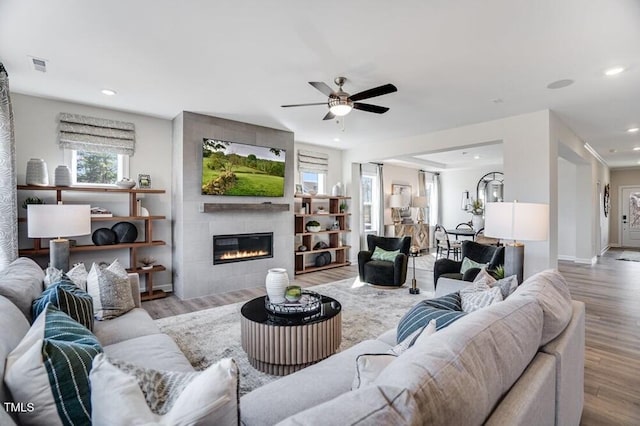 1021 Dillon Lake Dr, Knightdale, NC 27545 - living room featuring wood finished floors, ceiling fan, a tiled fireplace, recessed lighting, and baseboards