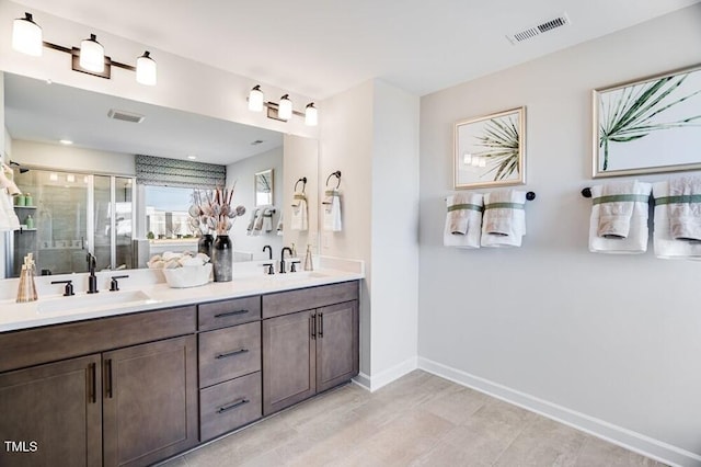 1021 Dillon Lake Dr, Knightdale, NC 27545 - bathroom with double vanity, a stall shower, and baseboards
