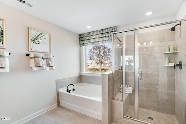 1021 Dillon Lake Dr, Knightdale, NC 27545 - full bath with a bath, a shower stall, baseboards, recessed lighting, and wood finished floors