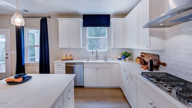 1021 Dillon Lake Dr, Knightdale, NC 27545 - kitchen with wall chimney exhaust hood, a sink, stainless steel appliances, white cabinetry, and light wood-style flooring