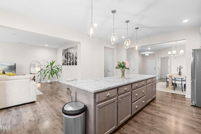 66 Arlie Ln, Lillington, NC 27546 - kitchen featuring freestanding refrigerator, wood finished floors, open floor plan, a center island, and baseboards