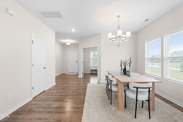 66 Arlie Ln, Lillington, NC 27546 - dining area with a chandelier, wood finished floors, and baseboards