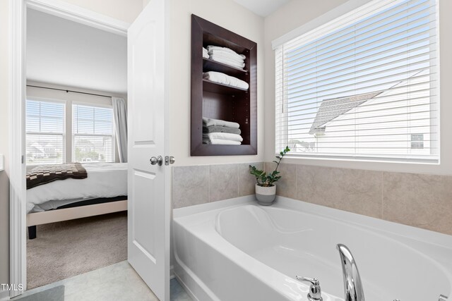 66 Arlie Ln, Lillington, NC 27546 - ensuite bathroom with a garden tub and tile patterned flooring