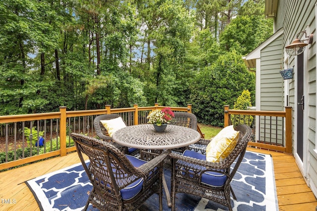 106 Fawley Ct, Cary, NC 27519 - wooden deck featuring outdoor dining area and view of wooded area