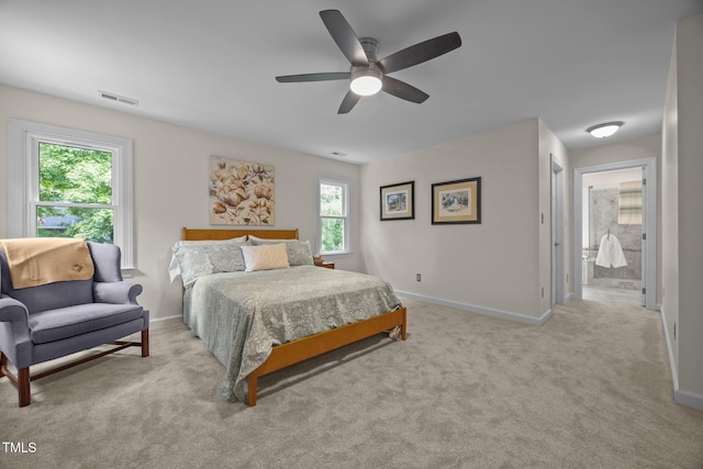 106 Fawley Ct, Cary, NC 27519 - carpeted bedroom with multiple windows, baseboards, ceiling fan, and ensuite bath