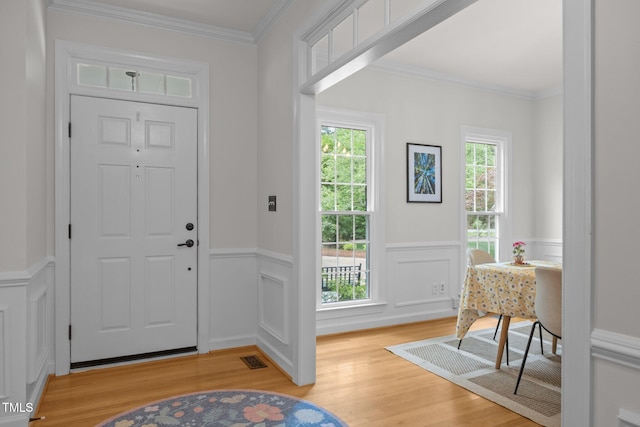 106 Fawley Ct, Cary, NC 27519 - entrance foyer featuring light wood-style flooring, wainscoting, and ornamental molding