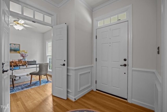 106 Fawley Ct, Cary, NC 27519 - foyer featuring light wood finished floors, plenty of natural light, a wainscoted wall, ceiling fan, and ornamental molding